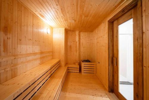 an empty sauna with wooden walls and a window at Wyndham Garden Grandworld Phu Quoc in Phu Quoc