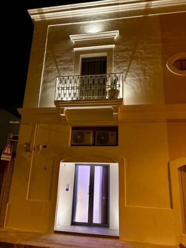 a building with a balcony on top of it at Regina Elena Suites & Private SPA in Sannicola