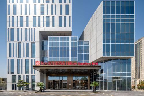 a rendering of a building with a hotel at Hilton Garden Inn Suzhou Kunshan in Suzhou