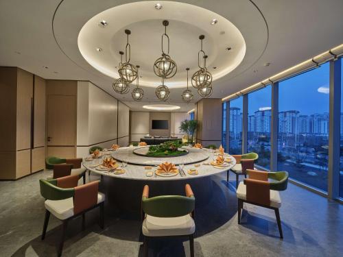 a large dining room with a large table and chairs at Doubletree By Hilton Yanji in Yanji