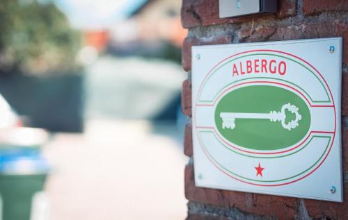 a sign on the side of a brick wall at La Boheme SMART Hotel in Turin