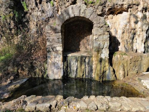 a tunnel in the side of a mountain with water at Views on the Hill in San Jose