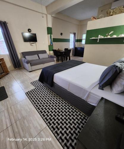 a hotel room with a bed and a couch at Carolina Point Resort in Crown Point