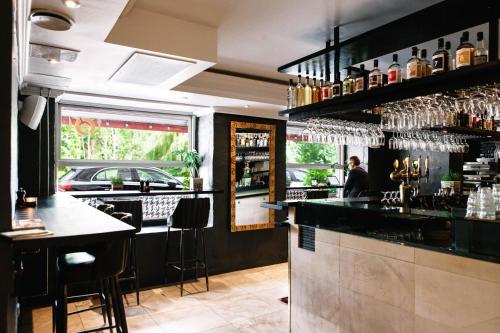 a bar with a person sitting at a counter at Babette Guldsmeden in Copenhagen
