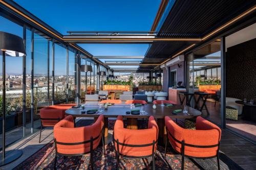 a patio with a table and chairs on a balcony at Swissôtel Tbilisi in Tbilisi City