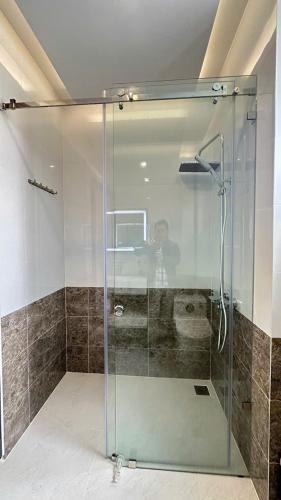 a shower with a glass door in a bathroom at Khách Sạn 1-CSLTDL-89- PHT in Xuan An