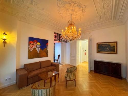 a living room with a couch and a chandelier at 7th HEAVEN Vienna Center Apartments in Vienna