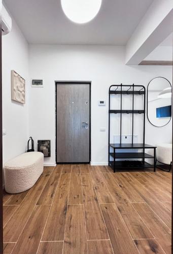 a room with a wooden floor and a door at GreenTeam Apartments in Râmnicu Vâlcea