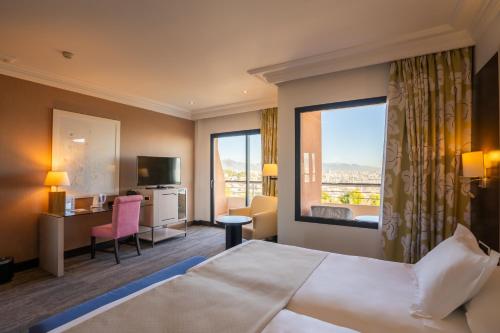 a hotel room with a bed and a large window at GPRO Valparaiso Palace & Spa in Palma de Mallorca