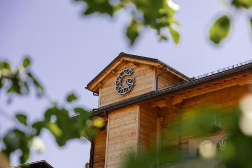 a clock tower on top of a wooden building at Boutique Hotel Glacier in Grindelwald