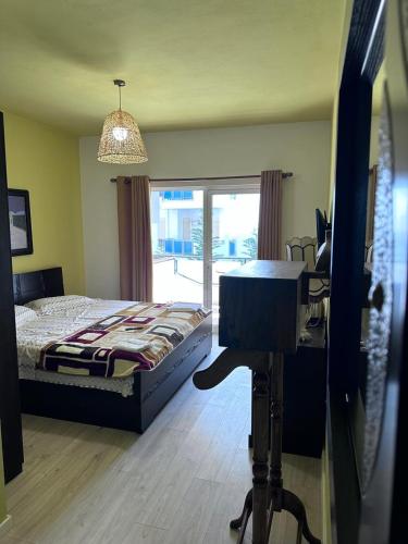 a bedroom with a bed and a desk with a desk at Mikpritja Pogradec, Tushemish 4 in Tushemisht