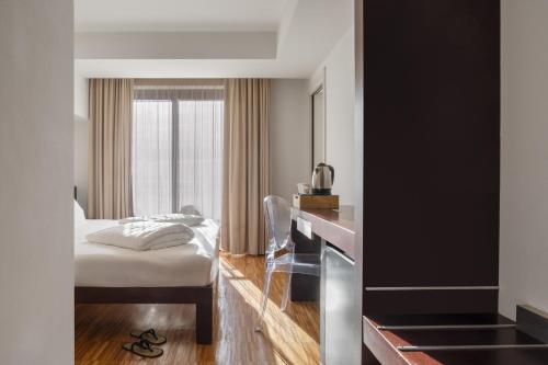 a hotel room with a bed and a window at Astoria Resort in Riva del Garda