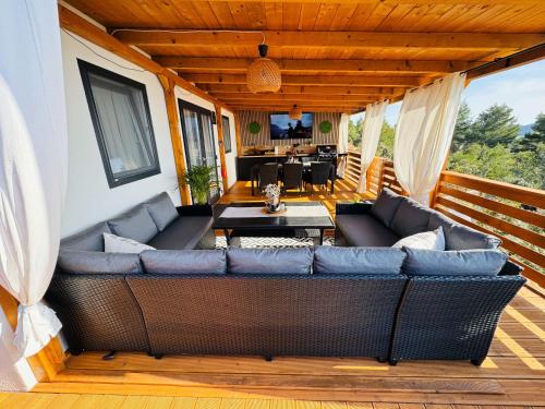 a living room with a couch on a deck at Serenity Mobile House in Drage