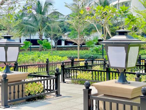 two lights on a fence next to a park at STAR BAY Residence Sihanoukville - 400m to Sokha Beach in Sihanoukville