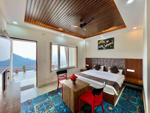 a bedroom with a large bed and a large window at Dhurva Hotel and Resort in Naugaon