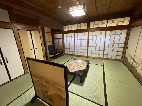 a room with a table and a chair in it at 宿坊宝塔寺 蓮Ren in Yoshino