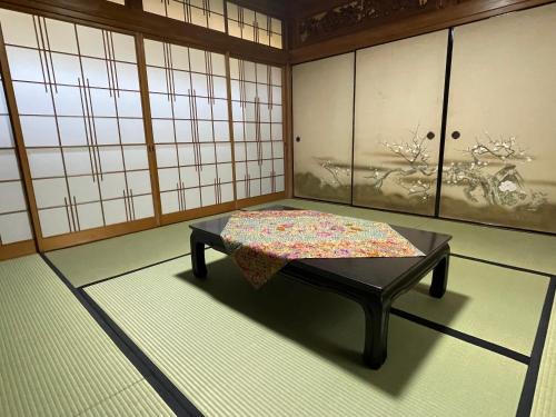 a room with a table in the middle of it at 宿坊宝塔寺 蓮Ren in Yoshino