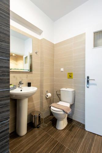 a bathroom with a toilet and a sink at Aris123 by Smart Cozy Suites - Apartments in the heart of Athens - 5 minutes from metro - Available 24hr in Athens