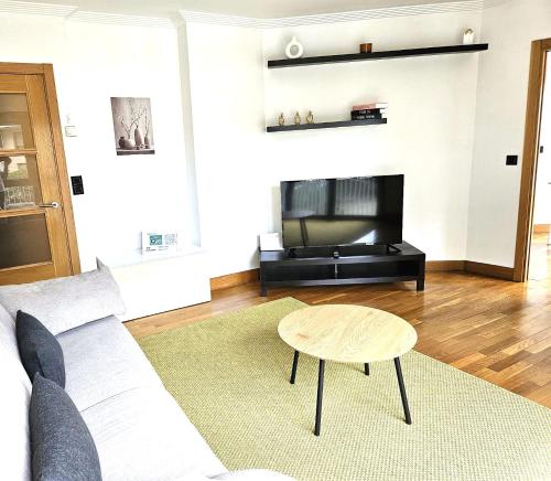 a living room with a couch and a table at Astigarraga Txotx by RUVA in Astigarraga
