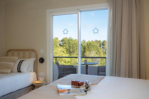 a hotel room with a bed and a large window at Casual Bahía Ibiza in San Antonio Bay