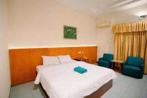 Postel nebo postele na pokoji v ubytování Dewi Ratih Hotel Batang