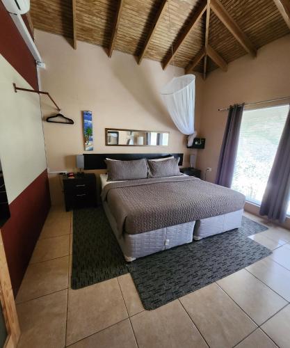 a bedroom with a bed and a large window at Carolina Point Resort in Crown Point
