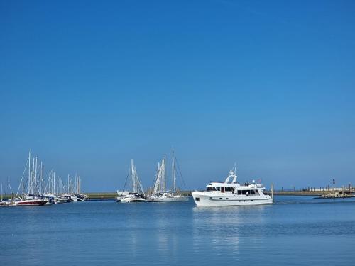 a group of boats sitting in the water at Ferienwohnung Buhne 2 in Norden