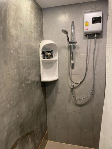 a bathroom with a shower with a soap dispenser on the wall at Rockstarvillas Condos Replay in Bophut