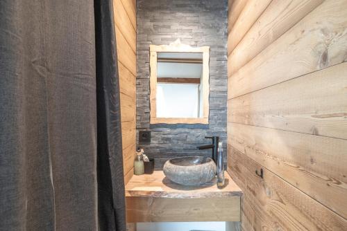 La salle de bains est pourvue d'un lavabo en pierre et d'une fenêtre. dans l'établissement Le Chappart - Carroz d'Arâches, à Arâches-la-Frasse