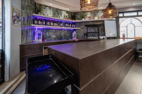 a bar with a wooden counter and purple lighting at Hostel Trastevere in Rome