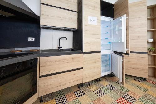 a kitchen with wooden cabinets and a refrigerator at Hostel Trastevere in Rome