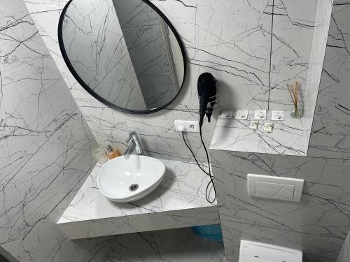 a bathroom with a sink and a mirror on the wall at 77/5 in Chişinău