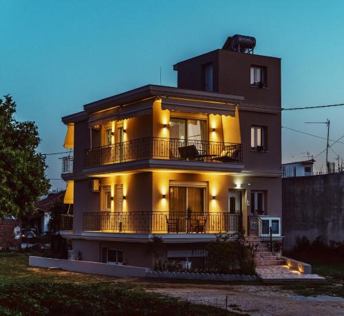 a building with lights on the side of it at K&E Guesthouse in Preveza