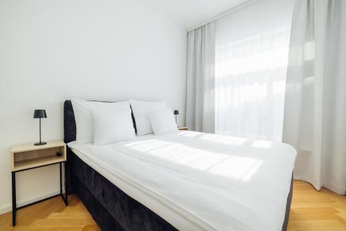 a large white bed in a room with a window at Hestia Hotel Barons Old Town in Tallinn