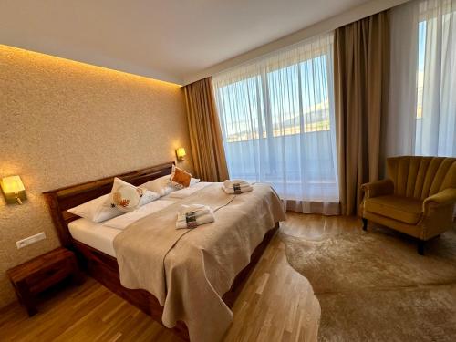 a hotel room with a bed and a chair at Vysoké Tatry - ISC RESORT in Mlynica