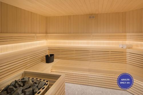 a large wooden sauna with a tub in it at Camping Homes Mon Perin in Bale