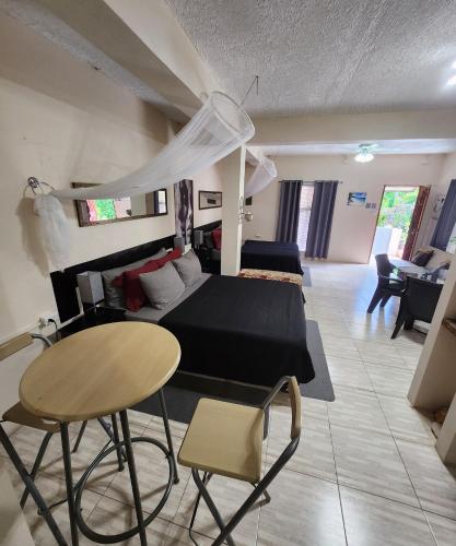 a bedroom and living room with a bed and a table at Carolina Point Resort in Crown Point