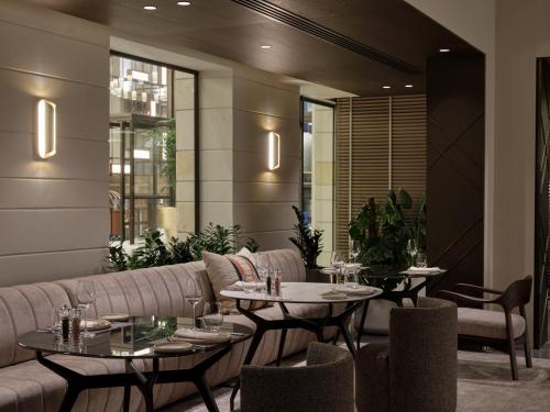 a restaurant with two tables and a couch at September Hotel Thessaloniki in Thessaloniki