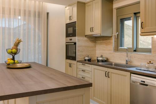a kitchen with a sink and a counter top at Anax by Vintage Travel in Ayia Evfimia