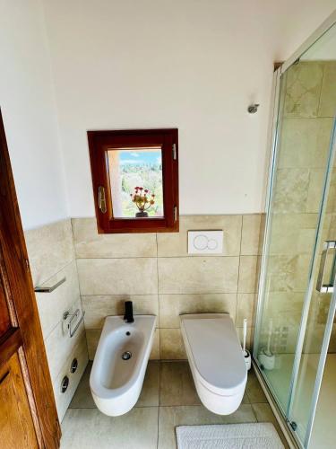 a bathroom with a toilet and a sink and a shower at Truffle N Bed in San Giovanni dʼAsso