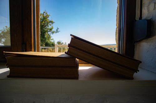 two books are sitting on a window sill at Villa Ikaros in Agia Triada