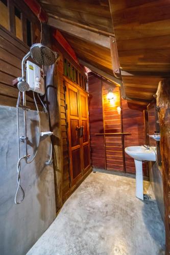 a bathroom with a sink and a toilet in a room at Chuenwaree Riverside Stay in Suratthani