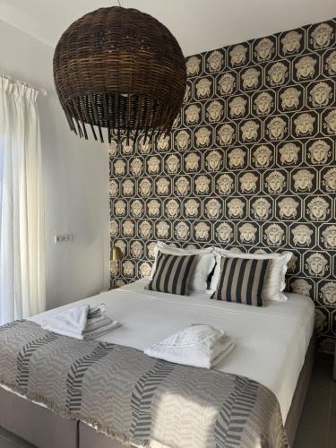 a bedroom with a large bed with a wall at Villa Ikaros in Agia Triada