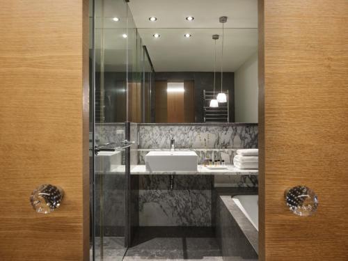 a bathroom with a sink and a mirror at September Hotel Thessaloniki in Thessaloniki