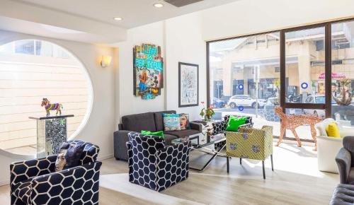 a living room with furniture and a large window at Best Western Regency Suites in Tel Aviv