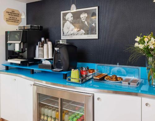 a counter with a blue counter top with food and drinks at Best Western Regency Suites in Tel Aviv