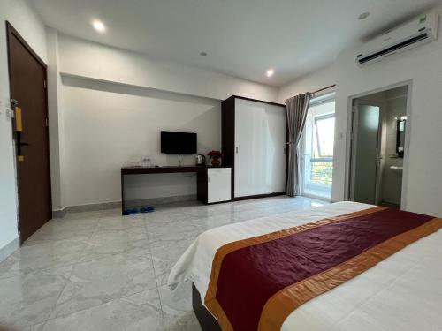a bedroom with a bed and a television in it at Rubyhotel nha trang in Nha Trang