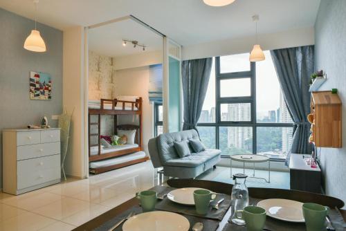 a living room with a table and a chair at The Robertson Bukit Bintang by Wowhome in Kuala Lumpur
