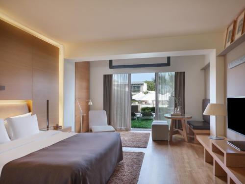 a hotel room with a large bed and a television at September Hotel Thessaloniki in Thessaloniki