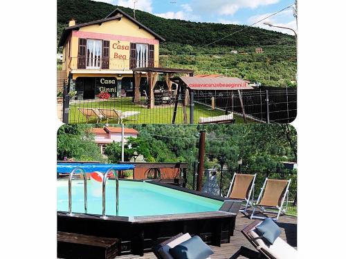 a house with a swimming pool in front of a house at Casa Ginni con Piscina e giardino in Caravonica